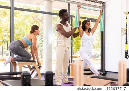 Aerobics pilates women with rubber bands closeup Aerobics pilates women with rubber bands closeup 113057747