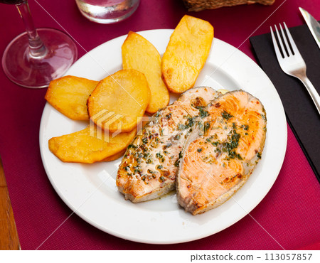 Deliciously steak of baked salmon with potatoes 113057857