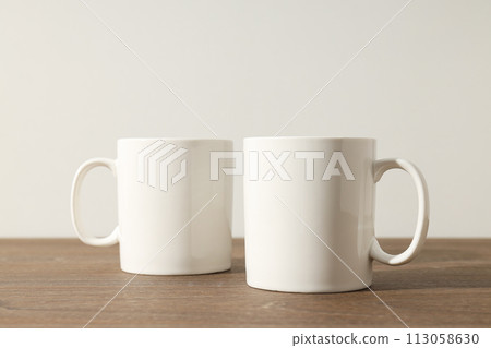 White beautiful cups on a wooden table White beautiful cups on a wooden table 113058630
