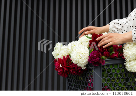 Flowers in a shopping cart, outdoors, summer. Flowers in a shopping cart, outdoors, summer. 113058661
