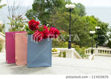 Flowers in paper, gift bags, on the street. 113058676