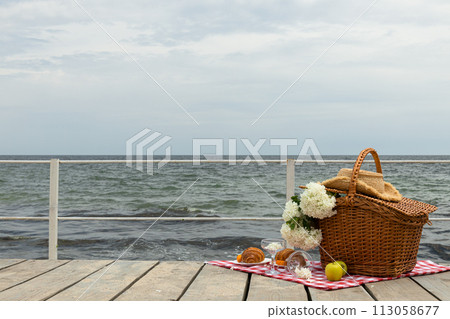 The concept of a picnic by the sea, with flowers. The concept of a picnic by the sea, with flowers. 113058677