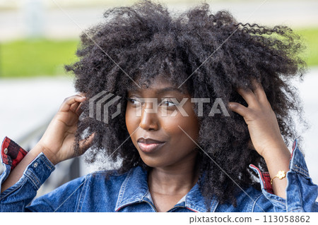 Stylish African American Woman with Natural Hair in Urban Setting Stylish African American Woman with Natural Hair in Urban Setting 113058862