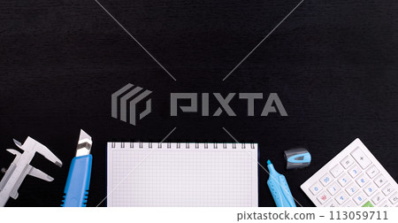 School supplies on black board background. Back to school concept School supplies on black board background. Back to school concept 113059711