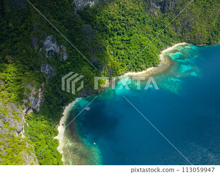 Pasandigan Cove with boats over clear water. Cadlao Island. El Nido, Palawan. Philippines. Pasandigan Cove with boats over clear water. Cadlao Island. El Nido, Palawan. Philippines. 113059947