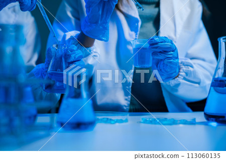 Science and medicine, scientist analyzing and dropping a sample into a glassware, experiments containing chemical liquid in laboratory on glassware, innovative and technology. 113060135
