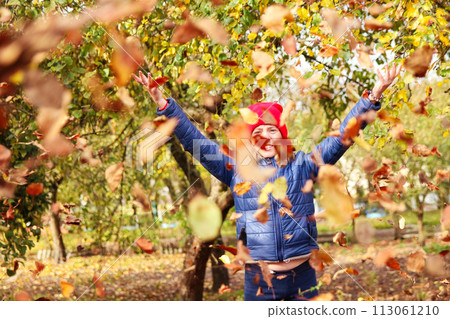 a girl joyfully tossing autumn leaves into the air against a backdrop of golden foliage, capturing the essence of the fall season and perfect for illustrating outdoor activities in parks a girl joyfully tossing autumn leaves into the air against a backdrop of golden foliage, capturing the essence of the fall season and perfect for illustrating outdoor activities in parks 113061210