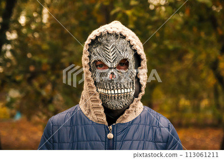 Halloween people portrait. Person in grim reaper mask standing on nature autumn background. Halloween horror. Skull ghost. Grim reaper 113061211