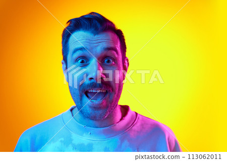 Excited man in tie-dye ping sweatshirt shirt with wide-eyed expression on gradient yellow orange background in neon light. Big sales, winning prizes, surprise Excited man in tie-dye ping sweatshirt shirt with wide-eyed expression on gradient yellow orange background in neon light. Big sales, winning prizes, surprise 113062011
