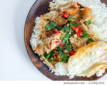 Rice topped with crispy pork belly with Thai basil and fried egg Rice topped with crispy pork belly with Thai basil and fried egg 113062934