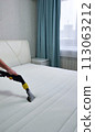 The concept of cleaning and housekeeping. Dry cleaning of the mattress by a professional method. 113063212