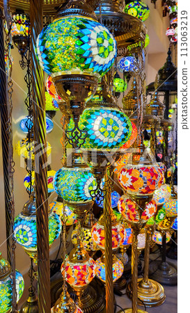 Beautiful lamps in Arabic style. Colorful hanging lanterns in traditional Arabic style handmade in the souvenir shop 113063219