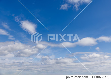 Vast sky in light blue, puffy clouds moving towards horizon for calm scenes Vast sky in light blue, puffy clouds moving towards horizon for calm scenes 113063343