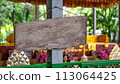 wooden signboard hanging on the clothesline 113064425