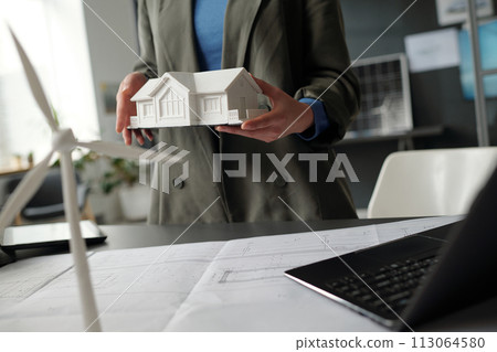 Female architect presenting house model Female architect presenting house model 113064580