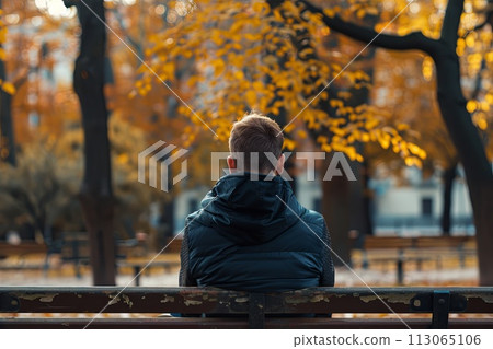 Man Sitting on Bench in Park 113065106