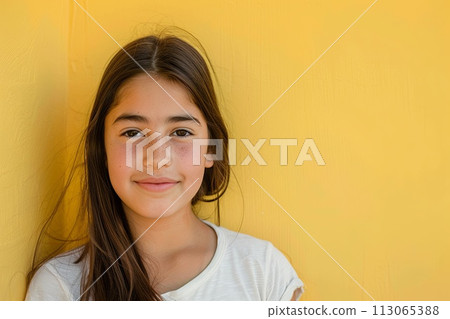 Young Girl Standing Against a Yellow Wall 113065388
