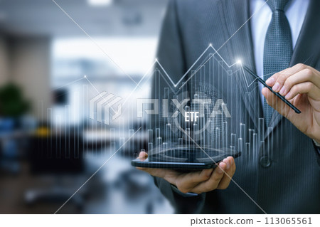 An investor analyzes the ETF market traffic graph. An investor analyzes the ETF market traffic graph. 113065561