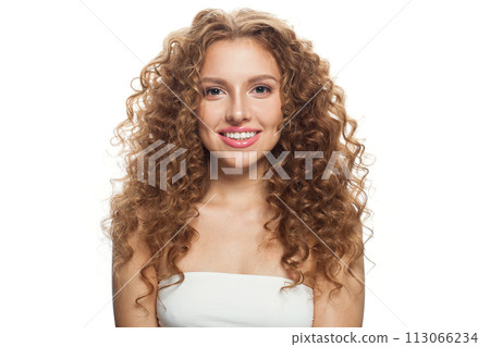 Positive young woman with natural make-up, clear fresh skin and wavy hairstyle on white background 113066234