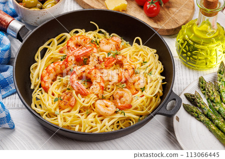 A delightful Italian pasta adorned with shrimps A delightful Italian pasta adorned with shrimps 113066445