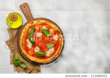 Margarita pizza with tomatoes, mozzarella cheese and basil Margarita pizza with tomatoes, mozzarella cheese and basil 113066452