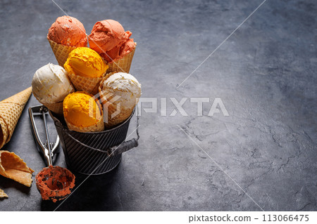 Assorted ice cream flavours in delightful waffle cones 113066475