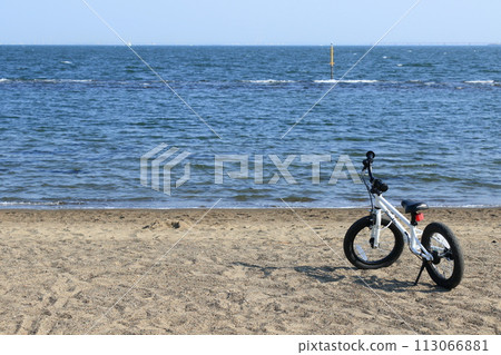 Children's bikes on the beach, bicycles on the beach 113066881