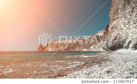 Abstract nature summer ocean sunset sea background. Small waves on water surface in motion blur with bokeh lights from sunrise. Holiday, vacation and recreational background concept 113067017