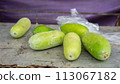 fresh green cucumbers on a wooden table 113067182