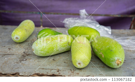 fresh green cucumbers on a wooden table fresh green cucumbers on a wooden table 113067182