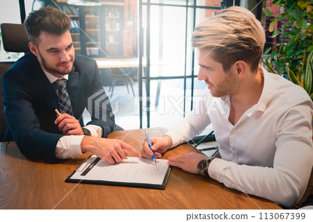 Business people negotiating a contract 113067399