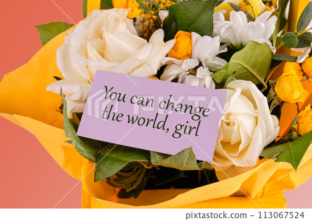 You can change the world, girl text written on a purple business card in a bouquet of flowers 113067524