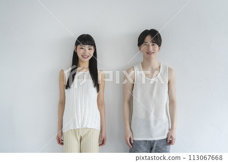 Smiling young man and woman looking at camera 113067668