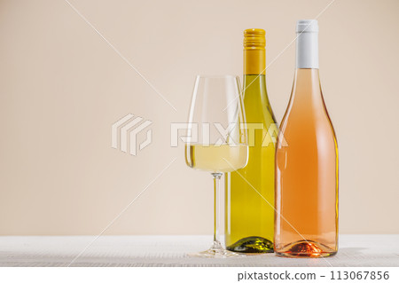 Rose and White Wine Bottles on Table Rose and White Wine Bottles on Table 113067856