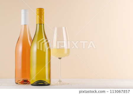 Rose and White Wine Bottles on Table 113067857