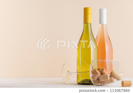 Rose and White Wine Bottles on Table 113067860