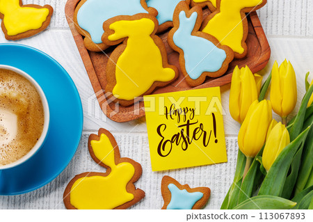Easter Bunny-Shaped Gingerbread Cookies, Yellow Tulips, and Greeting card 113067893