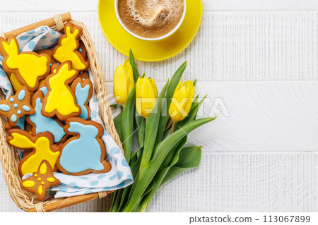 Easter Bunny-Shaped Gingerbread Cookies, Yellow Tulips, and Coffee Cup 113067899