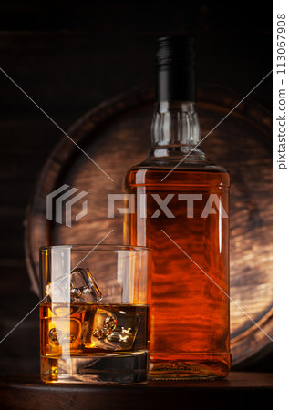 Glass and bottle with whiskey 113067908