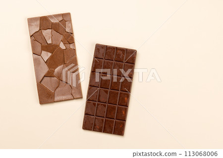 Chocolate bars on beige background Chocolate bars on beige background 113068006