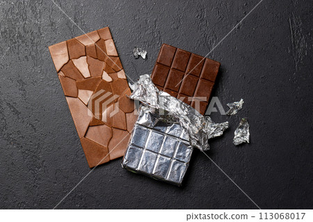 Two chocolate bars on stone background Two chocolate bars on stone background 113068017