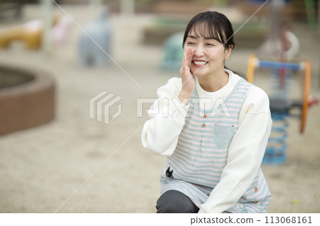 Nursery teacher watching over children in the park 113068161