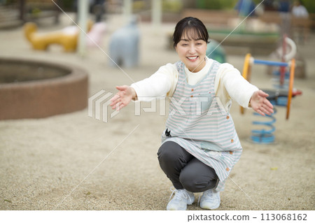Nursery teacher watching over children in the park 113068162