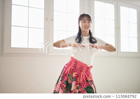 Middle-aged woman dancing hula dance 113068792
