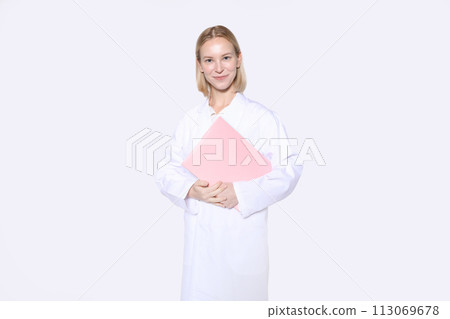 Smile of a female doctor holding a medical record Smile of a female doctor holding a medical record 113069678