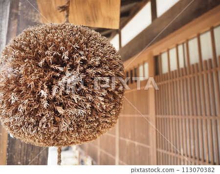 Cedar balls hanging from the eaves Cedar balls hanging from the eaves 113070382