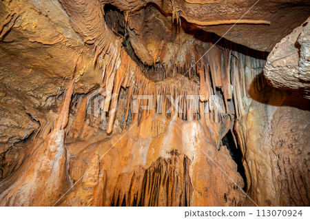Stalactite and stalagmite and other formations inside a beautiful cave. 113070924