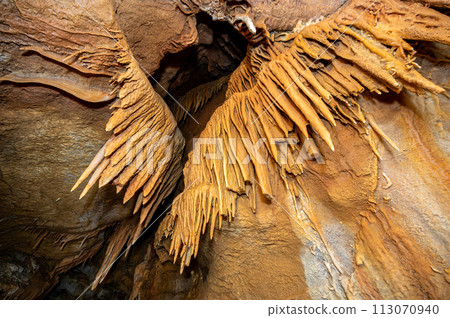 Stalactite and stalagmite and other formations inside a beautiful cave. 113070940