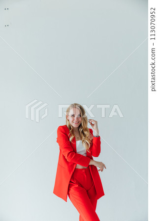 Beautiful blonde woman in red business suit Beautiful blonde woman in red business suit 113070952