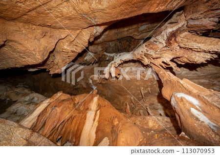 Stalactite and stalagmite and other formations inside a beautiful cave. 113070953